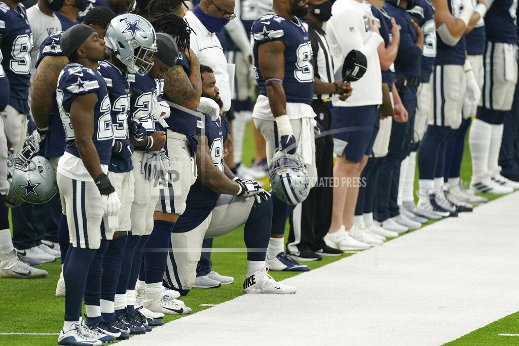Ashley Landis Dallas Cowboys' Dontari Poe (95) kneels during the national anthem before an NFL football game against the Los Angeles Rams Sunday, Sept. 13, 2020, in Inglewood, Calif. Poe became the first Cowboys player to ever kneel for the national anthem. (AP Photo/Ashley Landis)