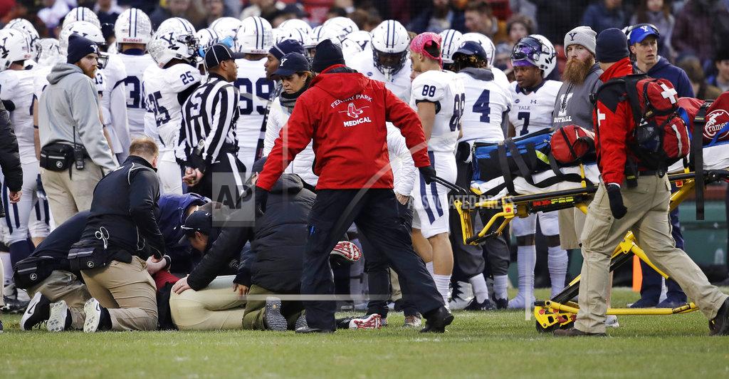 Charles Krupa Medical workers attend to injured Harvard quarterback Tom Stewart, left, after he was tackled by Yale defensive back Miles Oldacre during the second half of an NCAA college football game at Fenway Park in Boston, Saturday, Nov. 17, 2018. Harvard defeated Yale 45-27. Stewart left the field on a stretcher. (AP Photo/Charles Krupa)