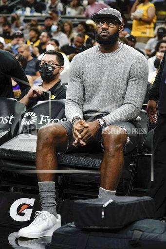 Los Angeles Lakers forward LeBron James sits on the bench during the first half of an NBA basketball game against the San Antonio Spurs on Tuesday, Oct. 26, 2021, in San Antonio, Texas. Los Angeles won 125-121 in overtime. (AP Photo/Darren Abate)