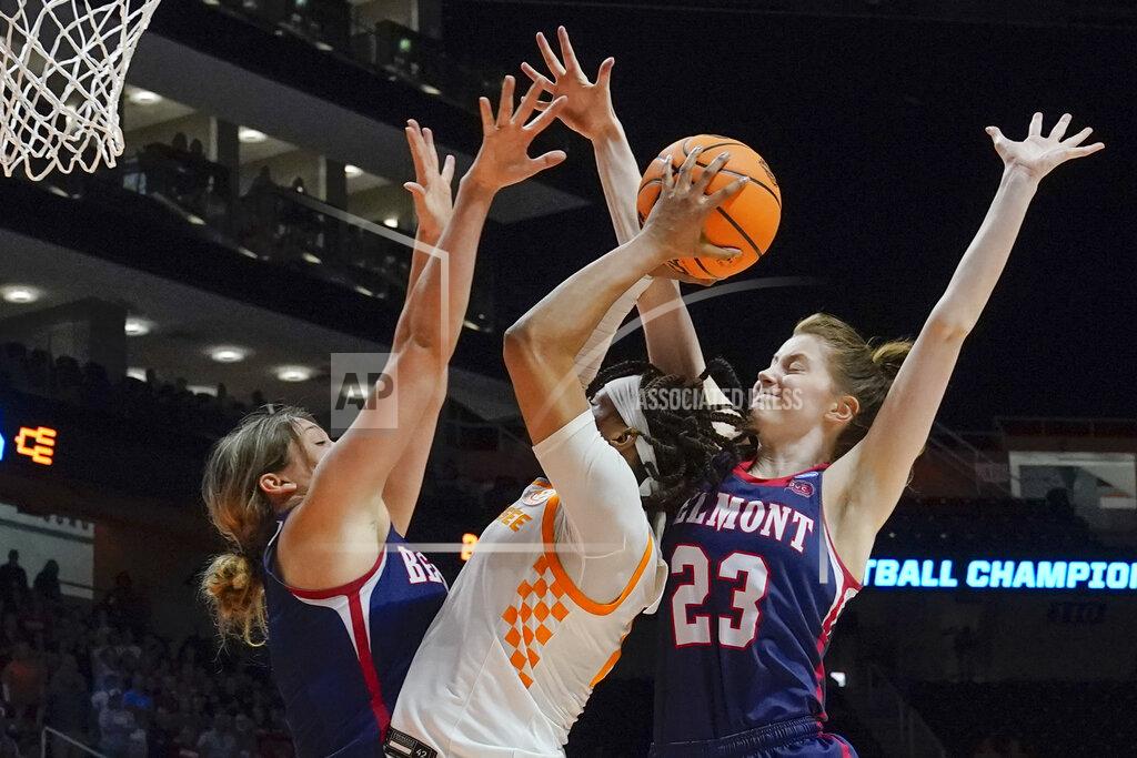 Mark Humphrey Tennessee's Alexus Dye, center, tries to shoot from between Belmont's Madison Bartley, left, and Belmont's Nikki Baird (23) in the second half of a women's college basketball game in the second round of the NCAA tournament Monday, March 21, 2022, in Knoxville, Tenn. Tennessee won 70-67. (AP Photo/Mark Humphrey)