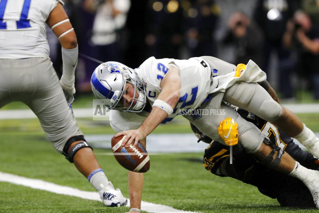 Gerald Herbert Middle Tennessee quarterback Brent Stockstill (12) dives across the goal line to avoid a safety as he is sacked by Appalachian State defensive lineman Okon Godwin (47) in the second half of the New Orleans Bowl NCAA college football game in New Orleans, Saturday, Dec. 15, 2018. Appalachian State won 45-13.(AP Photo/Gerald Herbert)