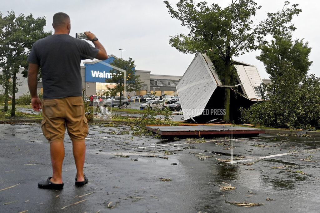 Tom Gralish A man takes a photo of the storm damage at the Walmart and Lowe's in Trevose, Pa. Thursday, July 29, 2021. Five people were injured Thursday when a building at a Bensalem auto dealership was destroyed by severe weather, authorities said.
The National Weather Service confirmed two tornados touched down in Bucks County, sending trees falling and debris flying.(Tom Gralish/The Philadelphia Inquirer via AP)