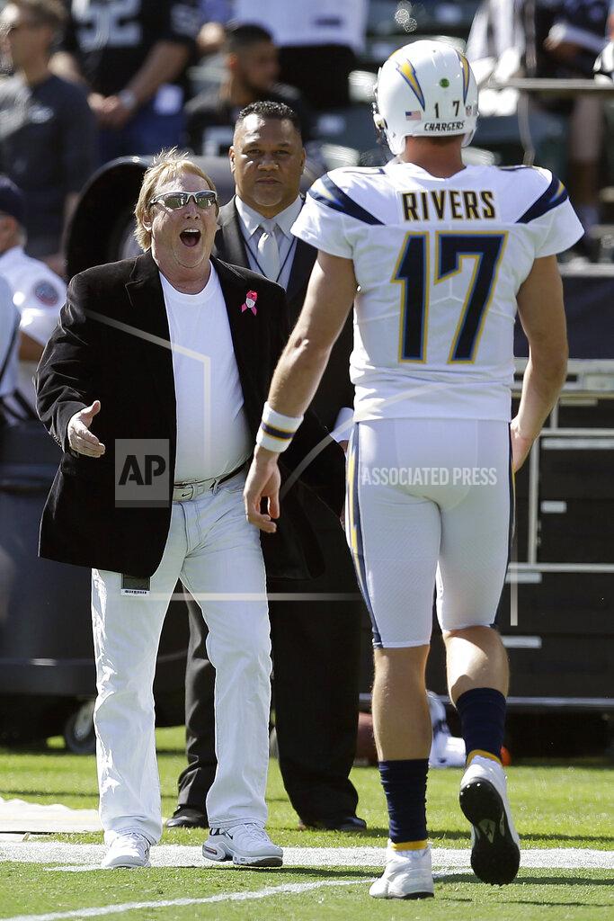 Ben Margot FILE - In this Oct. 15, 2017, file photo, Oakland Raiders owner Mark Davis, left, greets Los Angeles Chargers quarterback Philip Rivers (17) before an NFL football game between the Raiders and the Chargers in Oakland, Calif. From his first career start in 2006 to some riveting comebacks and crushing defeats, Chargers quarterback Philip Rivers has had plenty of memorable experiences playing against the Raiders at the Oakland Coliseum.
So there will be a bit of nostalgia when Rivers plays his final scheduled game there Thursday night, Nov. 17, 2019, when the Chargers (4-5) take on the Raiders (4-4) in a game crucial for both teams' playoff hopes. (AP Photo/Ben Margot, File)