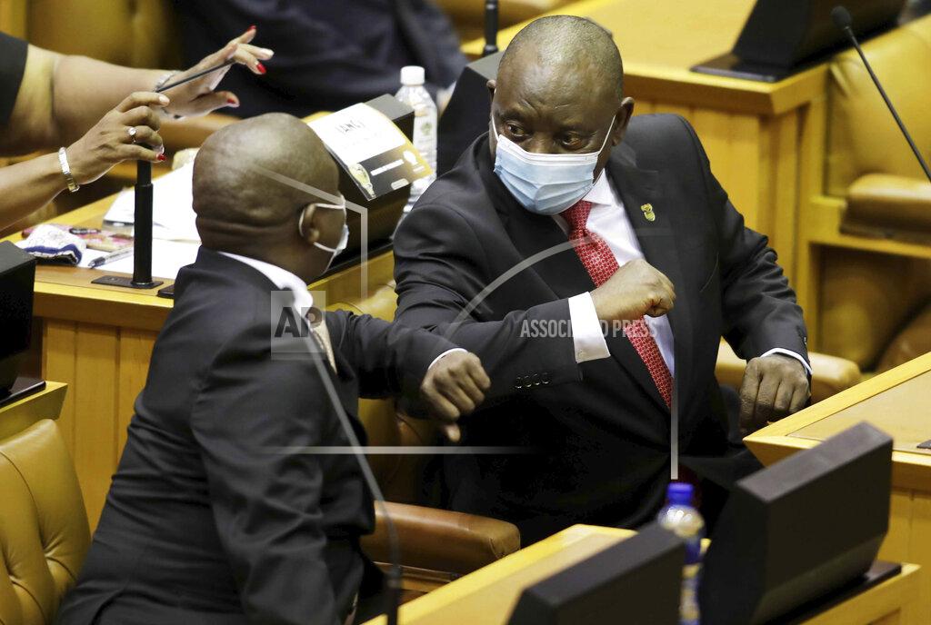 Esa Alexander South African President Cyril Ramaphosa, right, greets Deputy President David Mabuza at the State of the Nation Address in parliament in Cape Town, South Africa, Thursday, Feb. 11, 2021. Prior to his address Ramaphosa lit a candle for the some 46,000 people who have died from COVID-19 in the country. (Esa Alexander/Pool via AP)