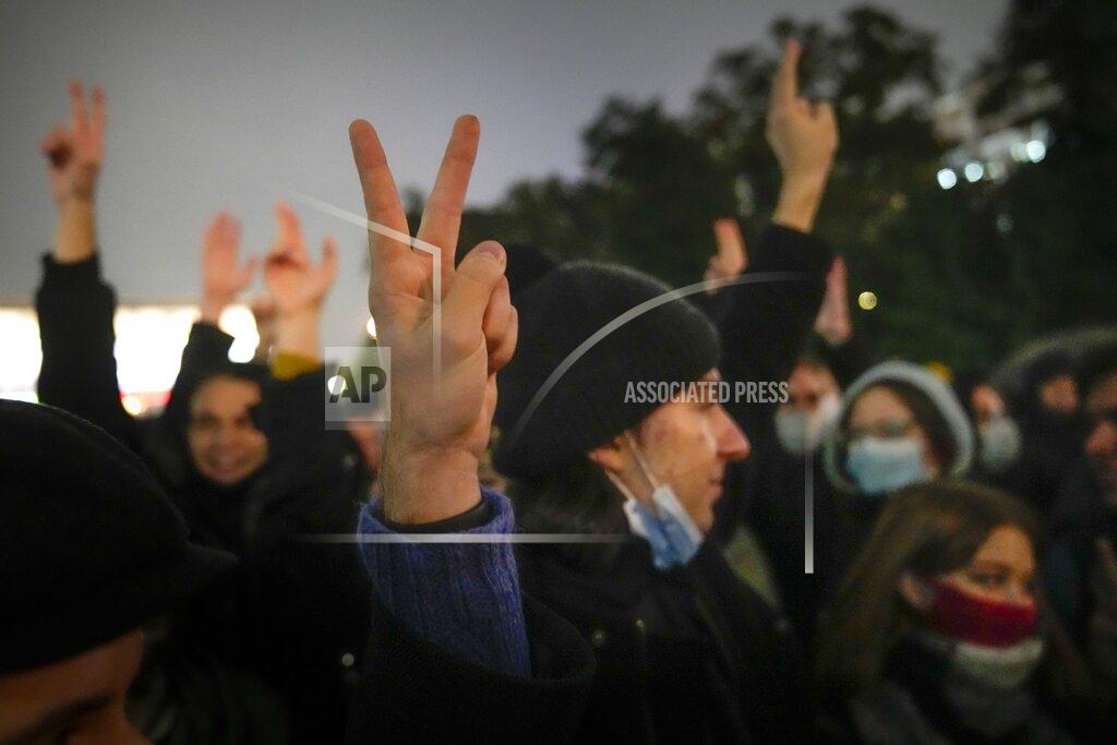 Pavel Golovkin People gesture while listening to a speaker during a protest against the results of the Parliamentary election in Moscow, Russia, Monday, Sept. 20, 2021. The results in the other six regions that were allowed to vote online have been detailed. In Moscow, approval of the ruling party has always been particularly low and protest voting has been widespread. Candidates from the Communist Party called for demonstrations later in the day. (AP Photo/Pavel Golovkin)