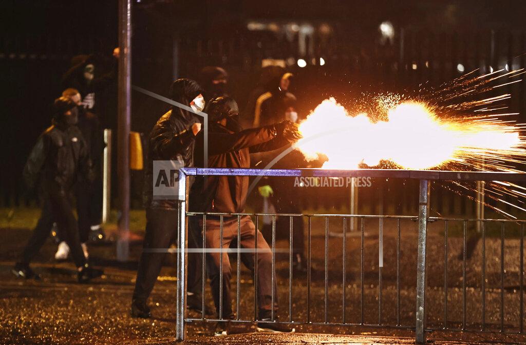 Liam Mcburney Youths fire fireworks at the PSNI on the Springfield road, during further unrest in Belfast, Northern Ireland, Thursday, April 8, 2021. Police and politicians in Northern Ireland have appealed for calm after a third night of violence that saw Protestant youths start fires and pelt officers with bricks and gasoline bombs. The flareups come amid rising tensions over post-Brexit trade rules for Northern Ireland and worsening relations between the parties in the Protestant-Catholic power-sharing Belfast government. (Liam McBurney/PA via AP)