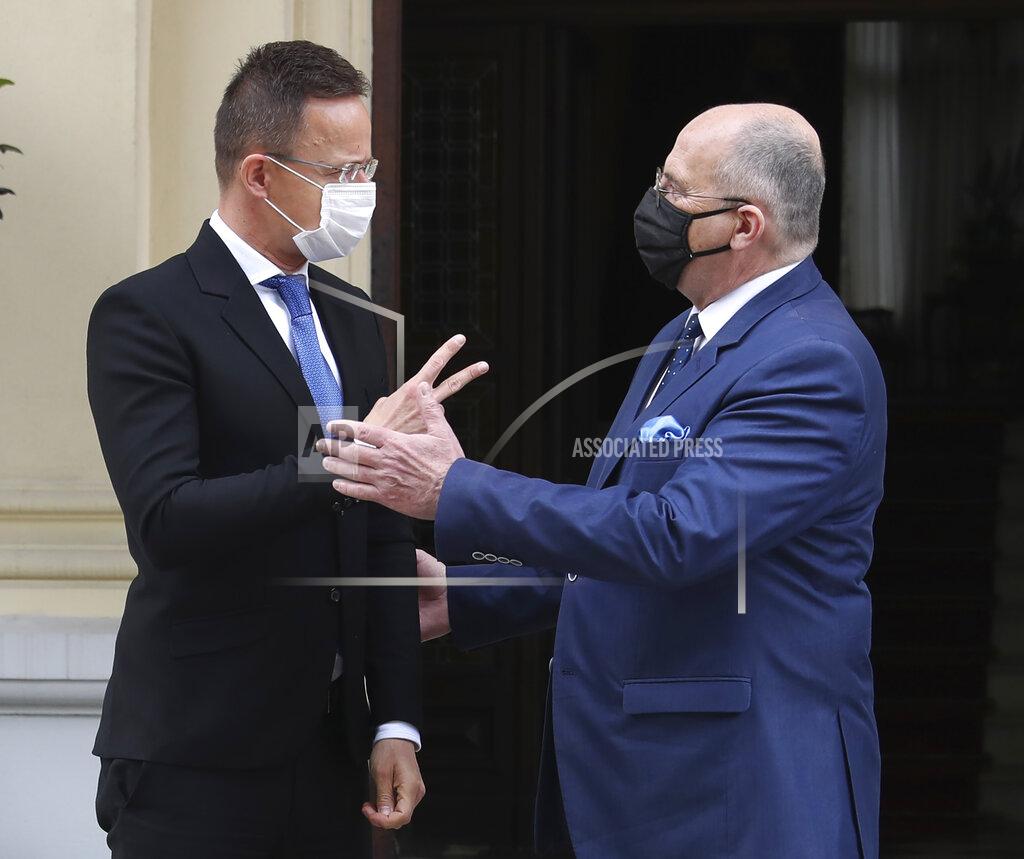 Czarek Sokolowski Poland's Foreign Minister Zbigniew Rau, right, walks with Hungarian Foreign Minister Peter Szijjarto during a meeting of foreign ministers from four central European countries known as the Visegrad Four in Lodz, Poland, Friday, May 14, 2021.(AP Photo/Czarek Sokolowski)