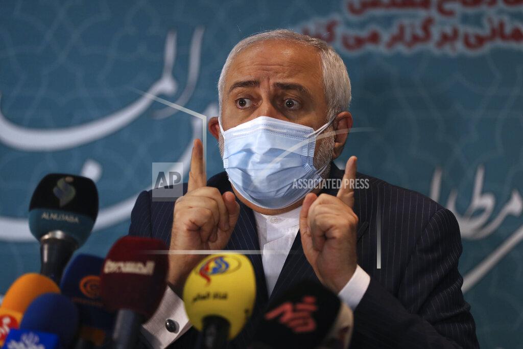 Vahid Salemi Iran's Foreign Minister Mohammad Javad Zarif speaks with journalists following a conference in Tehran, Iran, Tuesday, Feb. 23, 2021. Iran's foreign minister says the country has started implementing a law passed by the parliament to curb UN inspections into its nuclear program. Zarif reiterated that Iran would no longer share surveillance footage of its nuclear facilities with the U.N. agency. (AP Photo/Vahid Salemi)