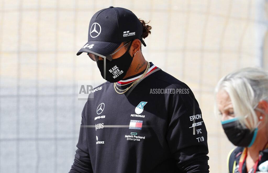 Armando Franca Mercedes driver Lewis Hamilton of Britain, left, walks near the track prior to the Formula One Portuguese Grand Prix at the Algarve International Circuit in Portimao, Portugal, Thursday, Oct. 22, 2020. The Formula One Portuguese Grand Prix will take place on Sunday. (AP Photo/Armando Franca)