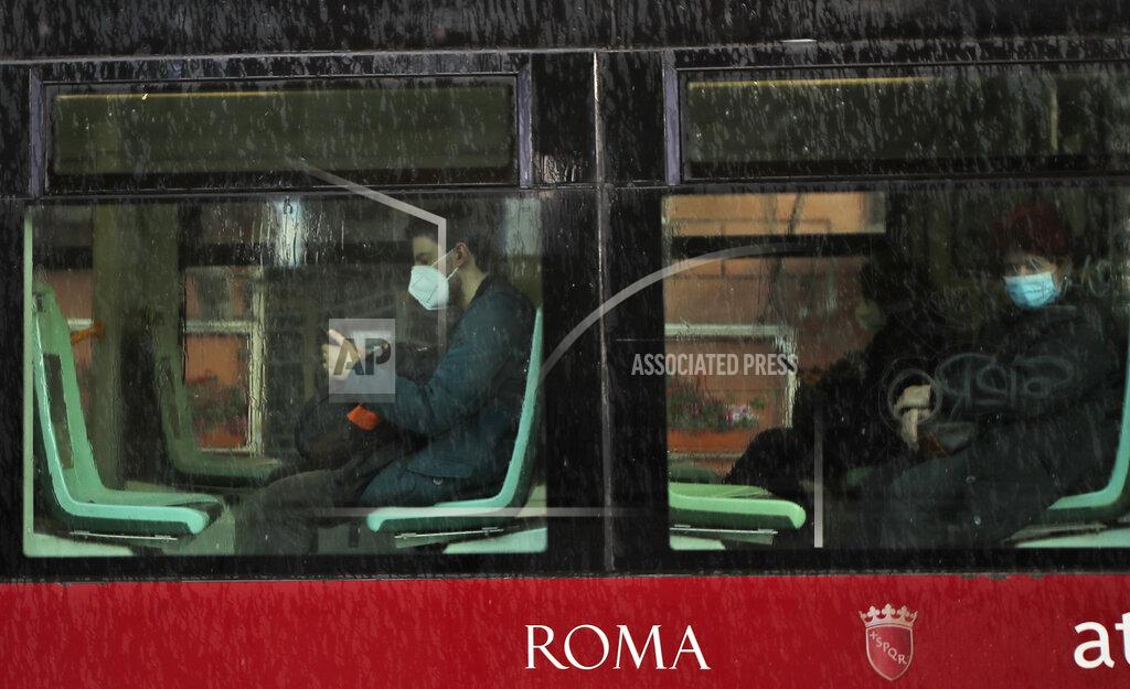 Alessandra Tarantino People wearing face masks to curb the spread of COVID-19, sit at distance in a tram in downtown Rome, Monday, March 15, 2021. Half of Italy's regions have gone into the strictest form of lockdown in a bid to curb the latest spike in coronavirus infections that have brought COVID-19 hospital admissions beyond manageable thresholds.(AP Photo/Alessandra Tarantino)