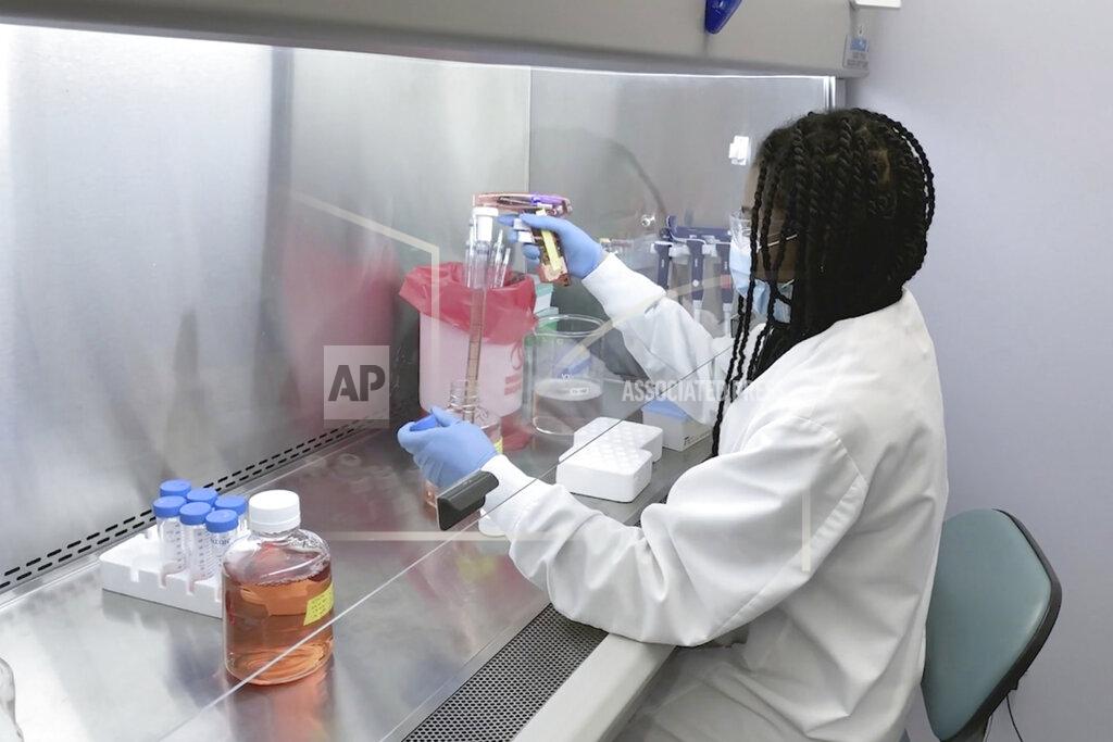 Uncredited In this undated image from video provided by Regeneron Pharmaceuticals on Friday, Oct. 2, 2020, a scientist works in the company's Infectious Disease Lab in New York state, for efforts on an experimental coronavirus antibody drug. Antibodies are proteins the body makes when an infection occurs; they attach to a virus and help the immune system eliminate it. (Regeneron via AP)