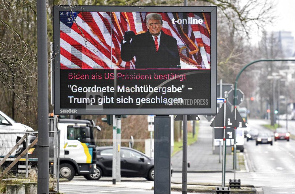 Martin Meissner A large news screen beside a street in Essen, Germany, showing US president Donald Trump, and a headline reading 'Biden as US president confirmed, orderly transfer of power - Trump declares defeat' on Thursday, Jan. 7, 2021. (AP Photo/Martin Meissner)