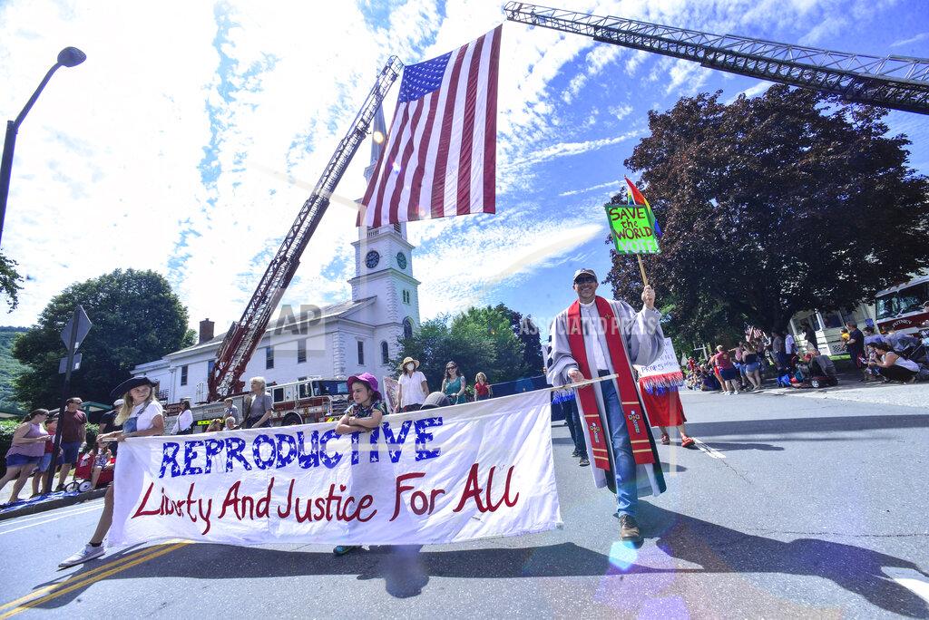 Kristopher Radder Various activities and protesters for different causes march down Main Street, in Brattleboro, Vt., during the Fourth of July parade on Monday, July 4, 2022. (Kristopher Radder/The Brattleboro Reformer via AP)