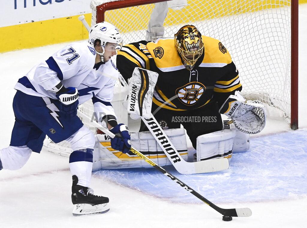 Nathan Denette Boston Bruins goaltender Tuukka Rask (40) makes a save against Tampa Bay Lightning center Anthony Cirelli (71) during the second period of an NHL hockey playoff game Wednesday, Aug. 5, 2020 in Toronto. (Nathan Denette/The Canadian Press via AP)