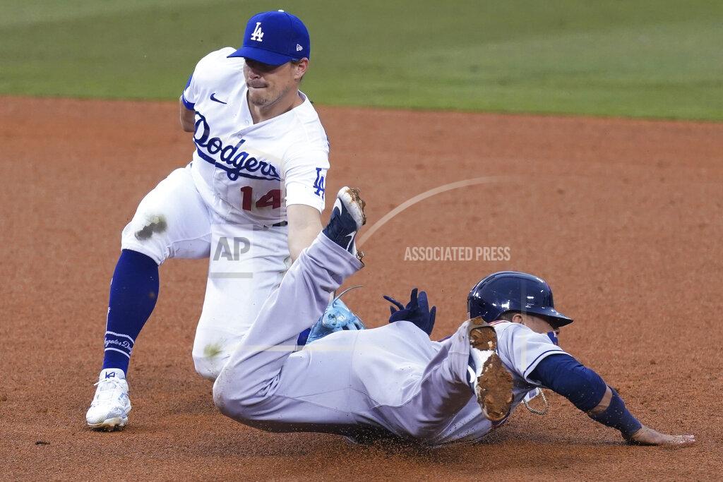 Ashley Landis Los Angeles Dodgers second baseman Enrique Hernandez, left, tags out Houston Astros' Yuli Gurriel at second base during the fourth inning of a baseball game at Dodger Stadium on Saturday, Sept. 12, 2020, in Los Angeles. (AP Photo/Ashley Landis)