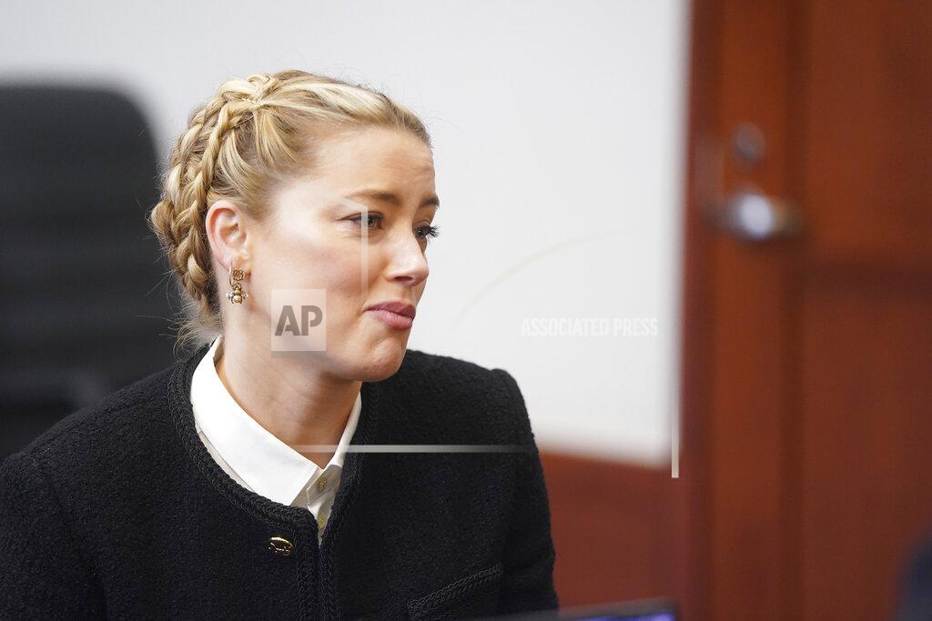 Shaw Thew Actor Amber Heard talks to her attorneys in the courtroom at the Fairfax County Circuit Courthouse in Fairfax, Va., Thursday, May 19, 2022. Actor Johnny Depp sued his ex-wife Amber Heard for libel in Fairfax County Circuit Court after she wrote an op-ed piece in The Washington Post in 2018 referring to herself as a "public figure representing domestic abuse." (Shawn Thew/Pool photo via AP)