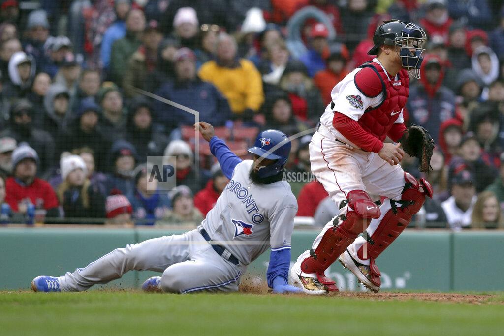 Charles Krupa Toronto Blue Jays' Teoscar Hernandez, left, scores past Boston Red Sox catcher Christian Vazquez on a single by Randal Grichuk during the seventh inning of the home opener baseball game, Tuesday, April 9, 2019, in Boston. (AP Photo/Charles Krupa)