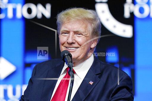FILE - Former President Donald Trump smiles as he pauses while speaking to supporters at a Turning Point Action gathering in Phoenix, July 24, 2021. Trump is slamming politicians who refuse to say whether they’ve received COVID-19 booster shots, calling them “gutless.” In an interview with One America News Network on Tuesday night, he said unnamed politicians have been afraid to admit they got the booster shot. (AP Photo/Ross D. Franklin, File)
