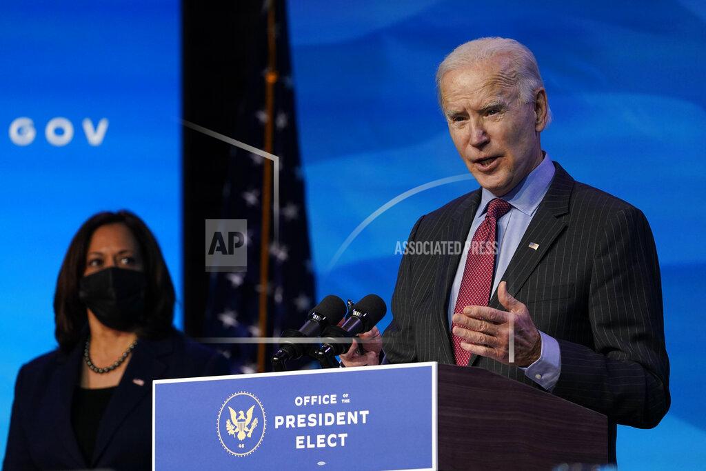 Susan Walsh Vice President-elect Kamala Harris listens as President-elect Joe Biden speaks during an event at The Queen theater in Wilmington, Del., Friday, Jan. 8, 2021, to announce key administration posts. (AP Photo/Susan Walsh)