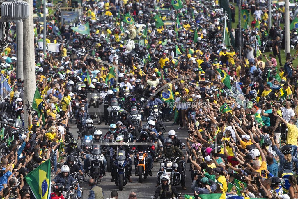 Bruna Prado Brazil's President Jair Bolsoanro, center, takes a motorcycle tour with supporters in Rio de Janeiro, Brazil, Sunday, May 23, 2021. (AP Photo/Bruna Prado)