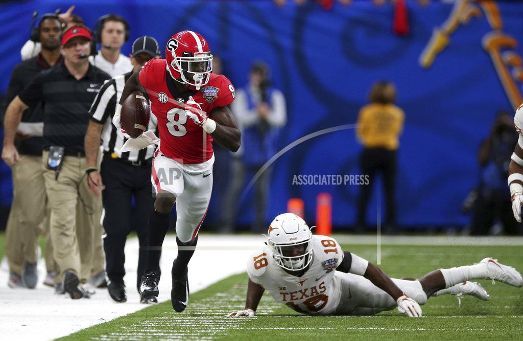 Rusty Costanza Georgia wide receiver Riley Ridley (8) runs past Texas defensive back Davante Davis (18) in the first half of the Sugar Bowl NCAA college football game in New Orleans, Tuesday, Jan. 1, 2019. (AP Photo/Rusty Costanza)