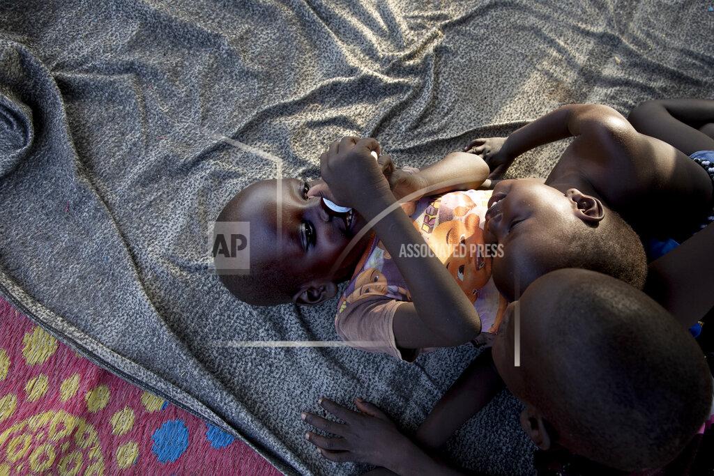 Adrienne Surprenant Two of Paska Itwari Beda's children play on a floor mat at her Juba, South Sudan home, Monday, May 24, 2021. Even before the pandemic hit, South Sudanese women were accustomed to building lives on the edge of uncertainty. But COVID-19 is shaking that fragile foundation. The country is just a decade old and one of the world's most difficult places to raise children. (AP Photo/Adrienne Surprenant)