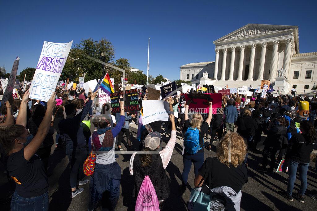 Jose Luis Magana EDS NOTE: OBSCENITY - Demonstrators rally at the Supreme Court, during the Women's March in Washington, Saturday, Oct. 17, 2020. (AP Photo/Jose Luis Magana)