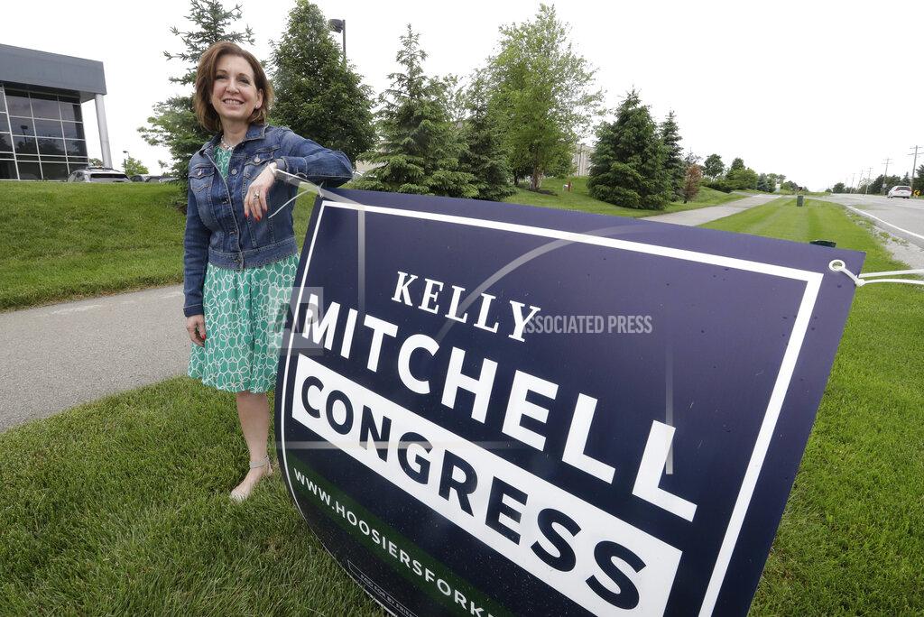 Darron Cummings Indiana State Treasurer Kelly Mitchell stands by a campaign sign, Thursday, May 28, 2020, in Westfield, Ind. Mitchell is a candidate for Indiana's 5th Congressional District. More Republican women than ever are seeking House seats this year after the 2018 election further diminished their limited ranks in Congress. But so far it appears that any gains this November could be modest. (AP Photo/Darron Cummings)