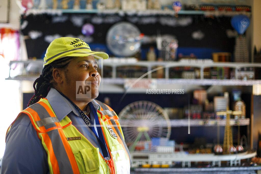 Matt Slocum Patrice Jetter, a furloughed school crossing guard, poses for a photograph, Thursday, July 23, 2020, in Hamilton, N.J. Jetter, who has cerebral palsy and partial hearing loss, wanted to work with kids when graduating from high school. (AP Photo/Matt Slocum)