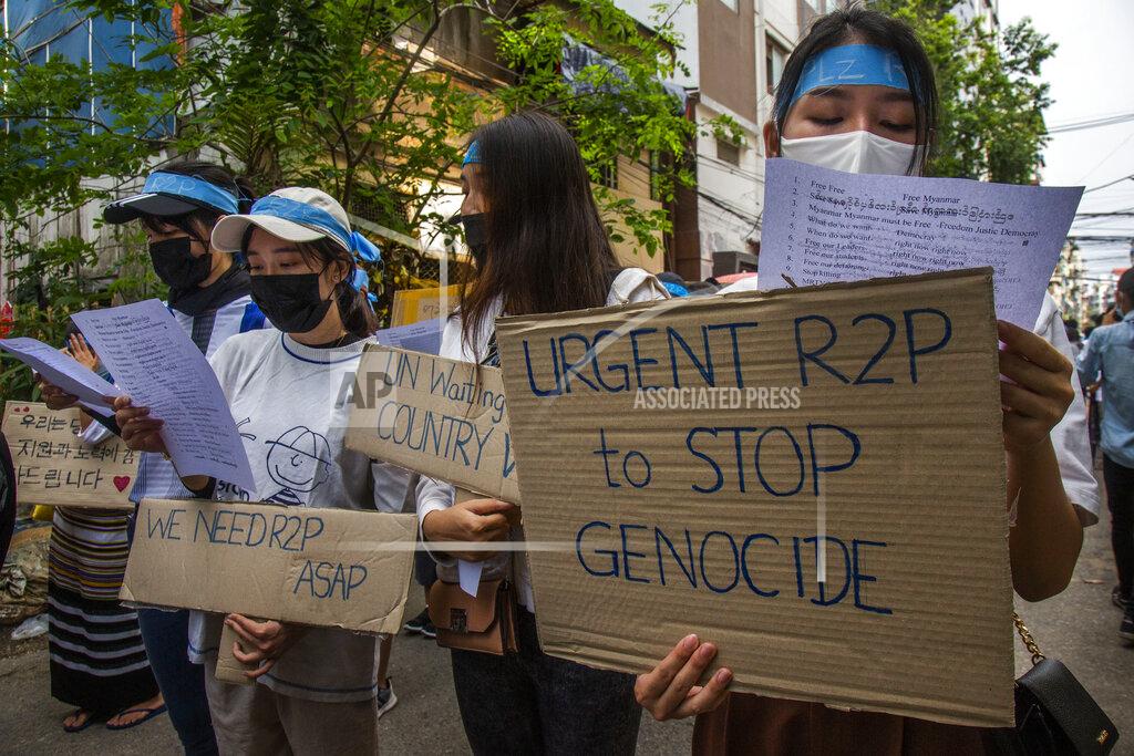 Uncredited Anti-coup protesters hold signs that refer to R2P, which means Responsibility to Protect, during a gathering in Ahlone township in Yangon, Myanmar Monday, April 12, 2021. The protesters have called for foreign intervention to aid them under the doctrine of Responsibility to Protect, or R2P, devised to deal with matters such as genocide, war crimes, ethnic cleansing and crimes against humanity. (AP Photo)