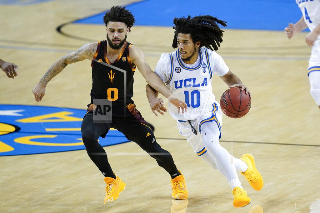 Ashley Landis Arizona State guard Holland Woods (0) defends against UCLA guard Tyger Campbell (10) during the second half of an NCAA college basketball game Saturday, Feb. 20, 2021, in Los Angeles. (AP Photo/Ashley Landis)
