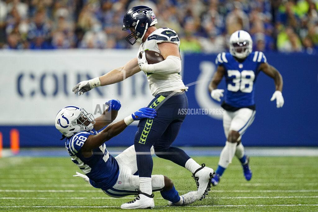 Charlie Neibergall Seattle Seahawks tight end Will Dissly (89) breaks the tackle of Indianapolis Colts inside linebacker Bobby Okereke (58) after catching a pass in the second half of an NFL football game in Indianapolis, Sunday, Sept. 12, 2021. (AP Photo/Charlie Neibergall)