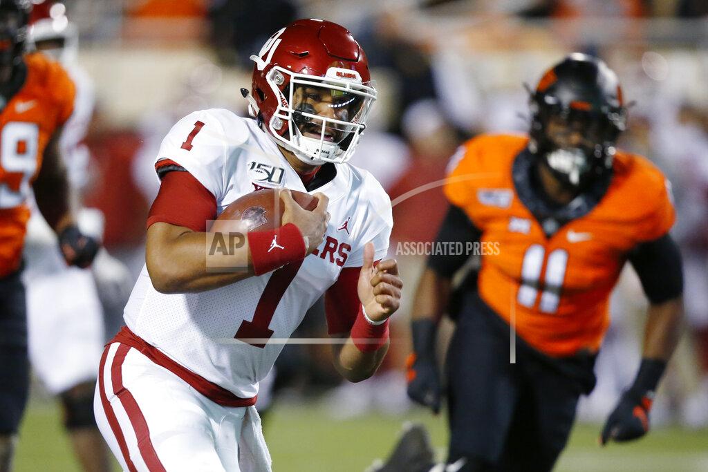 Sue Ogrocki Oklahoma quarterback Jalen Hurts (1) carries past Oklahoma State linebacker Amen Ogbongbemiga (11) for a touchdown in the first half of an NCAA college football game in Stillwater, Okla., Saturday, Nov. 30, 2019. (AP Photo/Sue Ogrocki)