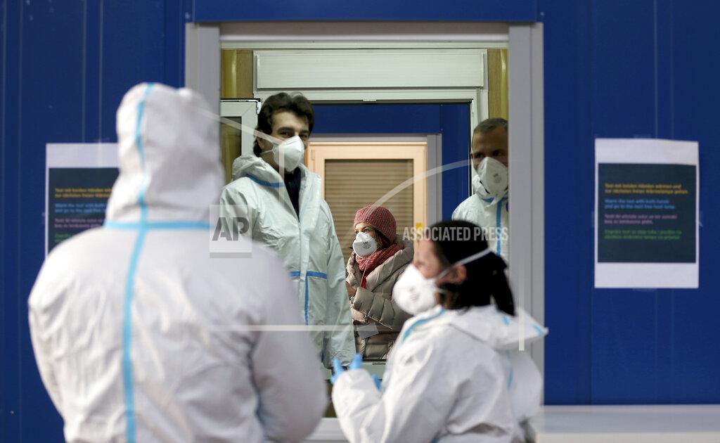 Ronald Zak A medical workers works in a COVID-19 set up for rapid new coronavirus testing in Vienna, Austria, Monday, Nov. 30, 2020. The Austrian government has moved to restrict freedom of movement for people, in an effort to slow the onset of the COVID-19 disease and the spread of the coronavirus. (AP Photo/Ronald Zak)