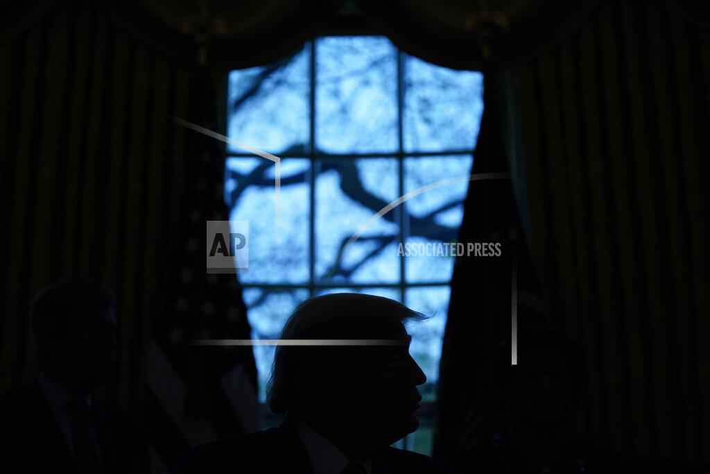 FILE - In this April 24, 2020, file photo President Donald Trump looks on during the signing of a coronavirus aid package to direct funds to small businesses, hospitals, and testing, in the Oval Office of the White House in Washington. (AP Photo/Evan Vucci, File)