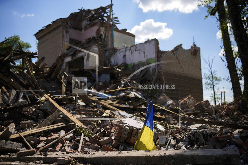 Francisco Seco A torn Ukraine flag waves among debris in a school destroyed in a Russian bombing in Bakhmut, eastern Ukraine, Tuesday, May 24, 2022. The town of Bakhmut has been coming under increasing artillery strikes, particularly over the last week, as Russian forces try to press forward to encircle the city of Sieverodonetsk to the northeast. (AP Photo/Francisco Seco)