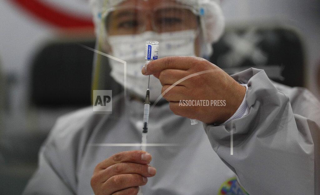 Juan Karita A healthcare worker prepares a dose of Russia's Sputnik V COVID-19 vaccine, at the Del Norte Hospital in El Alto, Bolivia, Saturday, Jan. 30, 2021. (AP Photo/Juan Karita)