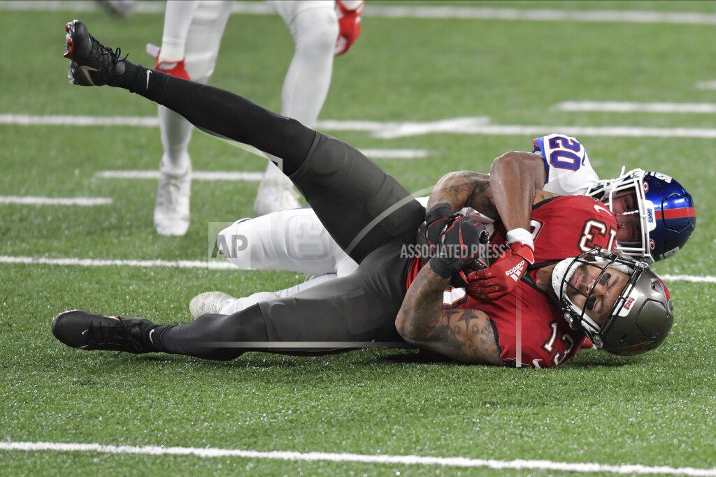Bill Kostroun New York Giants' Julian Love (20), top, brings down Tampa Bay Buccaneers' Mike Evans during the second half of an NFL football game, Monday, Nov. 2, 2020, in East Rutherford, N.J. (AP Photo/Bill Kostroun)