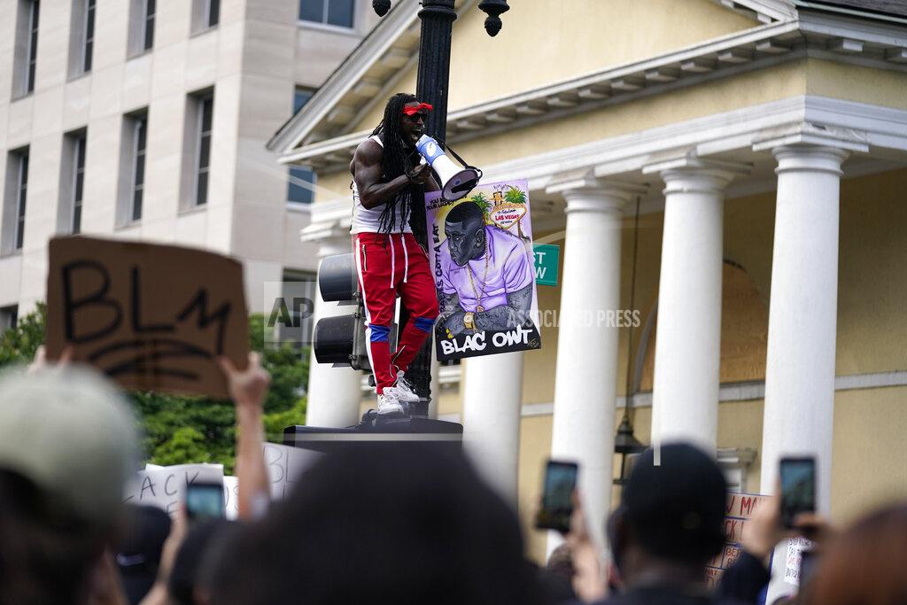 Evan Vucci With St. John's Church in the background, demonstrators protest, Thursday, June 4, 2020, near the White House in Washington, over the death of George Floyd, a black man who was in police custody in Minneapolis. Floyd died after being restrained by Minneapolis police officers. (AP Photo/Evan Vucci)