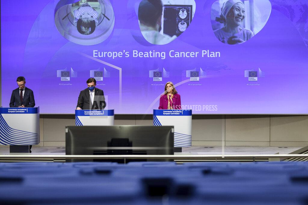 European Union Commissioner for Health Stella Kyriakides, right, and European Commissioner for Promoting our European Way of Life Margaritis Schinas, center, address a media conference at EU headquarters in Brussels, Wednesday, Feb. 3, 2021. The EU on Wednesday proposed a four-billion-euro (4.8 billion US dollar) plan aimed at improving the fight against cancer as the coronavirus pandemic tends to delay diagnoses and access to treatment across the 27-nation bloc. (Kenzo Tribouillard, Pool via AP)