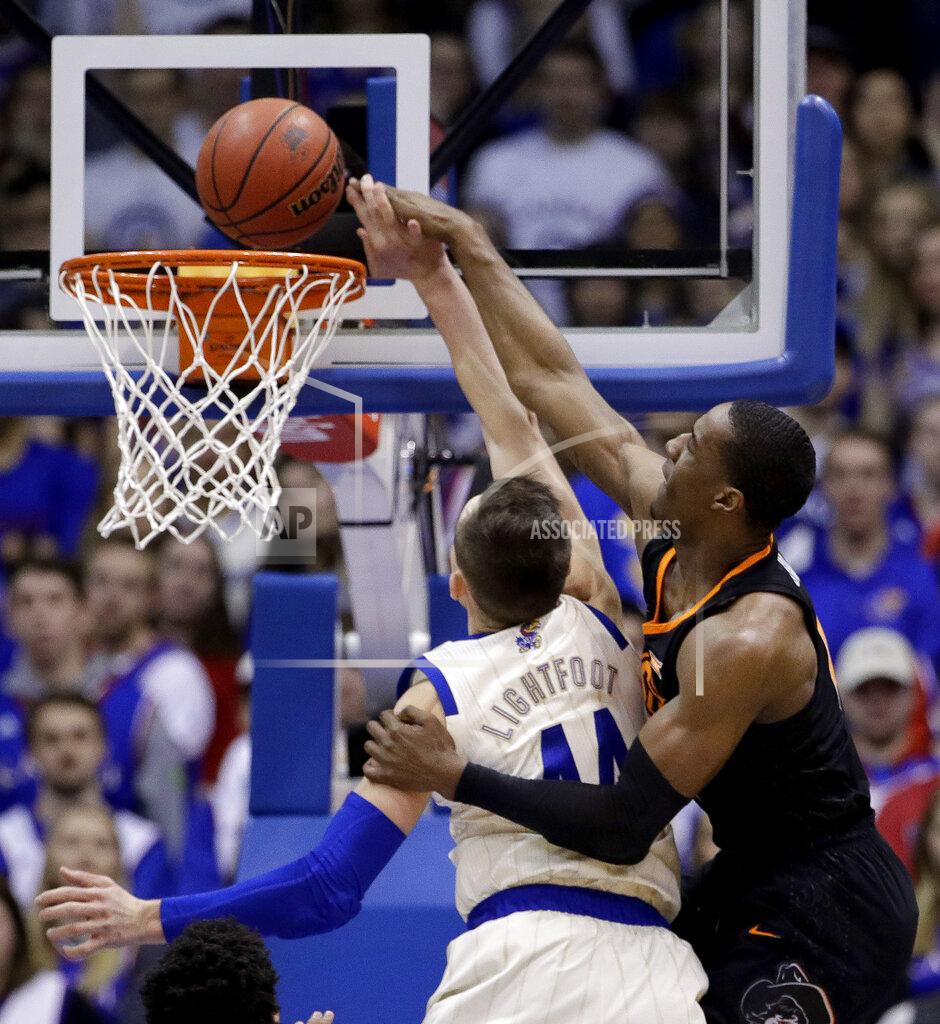 Charlie Riedel Kansas' Mitch Lightfoot (44) fouls Oklahoma State's Cameron McGriff as he shoots during the first half of an NCAA college basketball game Saturday, Feb. 9, 2019, in Lawrence, Kan. (AP Photo/Charlie Riedel)