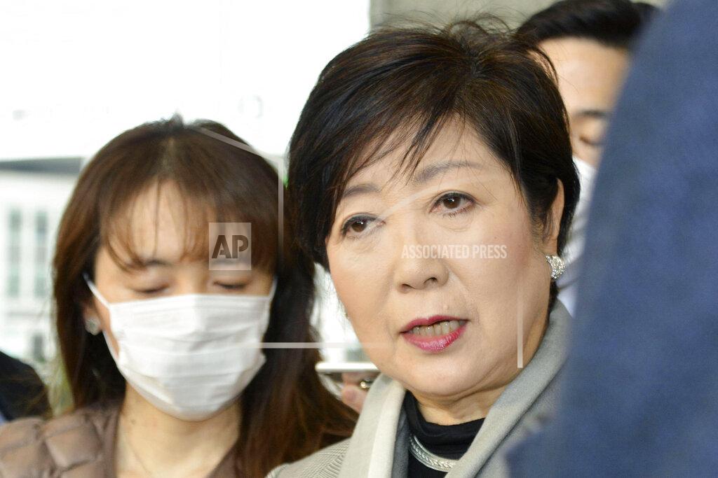 103902+0900 Tokyo Gov. Yuriko Koike, right, answers a reporter's question about the latest policy of International Olympic Committee, at Tokyo Metropolitan Government in Tokyo Monday, March 23, 2020. The IOC will take four weeks to weigh options for the Tokyo Games amid mounting calls from athletes and Olympic officials for a postponement due to the coronavirus pandemic. (Kyodo News via AP)