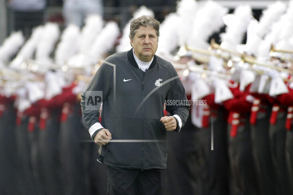 Young Kwak FILE - In this Nov. 16, 2019, file photo, Washington State head coach Mike Leach runs onto the field before an NCAA college football game against Stanford, in Pullman, Wash. Two people with knowledge of the decision says Mississippi State has hired Washington State's Mike Leach as its new head coach. The people spoke to The Associated Press on condition of anonymity Thursday, Jan. 9, 2020, because the school has not yet officially announced the move. Leach will replace Joe Moorhead, who was fired last week after two seasons. (AP Photo/Young Kwak, File)