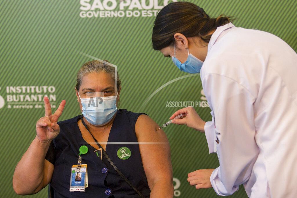 Carla Carniel A woman celebrates as she gets her shot of the COVID-19 vaccine produced by China’s Sinovac Biotech Ltd, at the Hospital das Clinicas in Sao Paulo, Brazil, Sunday, Jan. 17, 2021. (AP Photo/Carla Carniel)