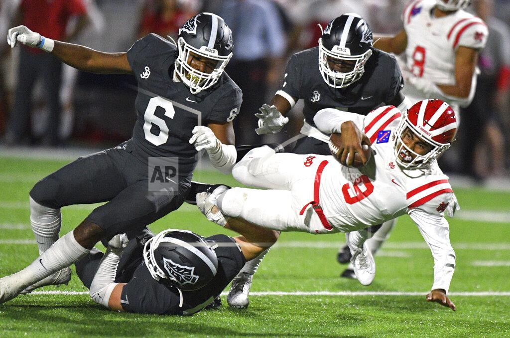 Scott Varley FILE - In this Friday, Oct. 25, 2019 file photo, Mater Dei quarterback Bryce Young is tackled after scrambling out of the pocket during a high school football game against St. John Bosco in Bellflower, Calif. Only Texas and Florida produce more major college football players than California, but across the state overall participation in the sport at the high school level is on the decline. The percentage of players competing at the highest level of college football who are from California has dropped, too. (Scott Varley/The Orange County Register via AP, File)