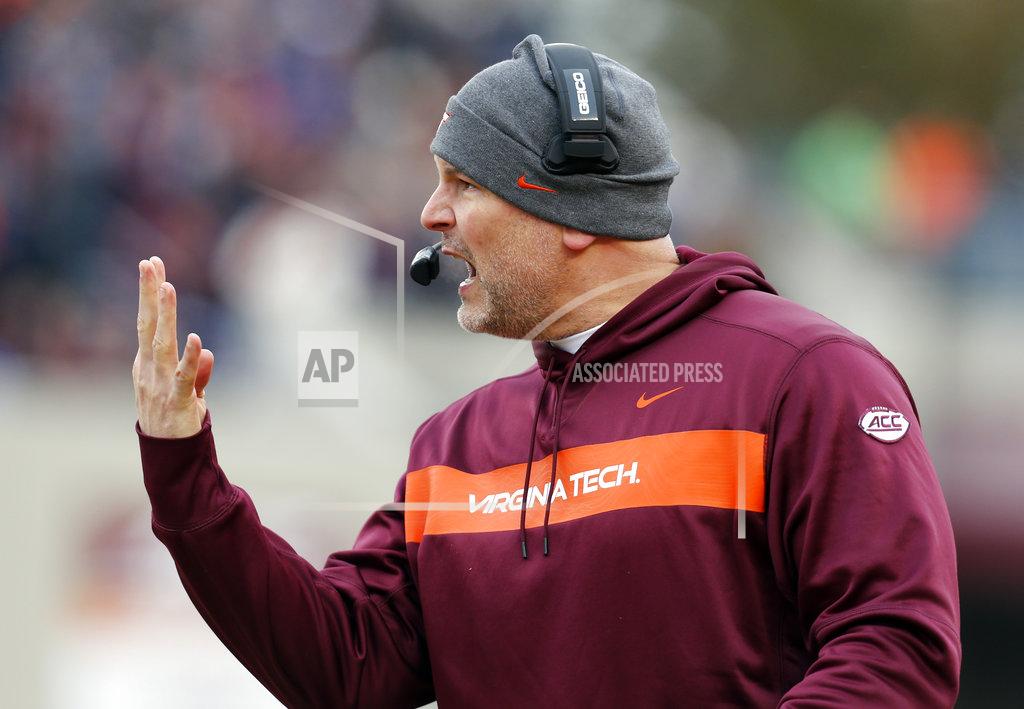 Steve Helber Virginia Tech head coach Justin Funente directs his team during the first half of an NCAA college football game in Blacksburg, Va., Friday, Nov. 23, 2018. (AP Photo/Steve Helber)