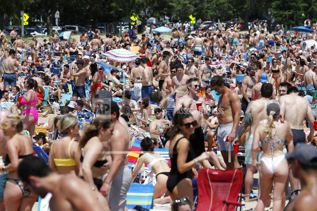 Michael Dwyer Crowds gather on L Street Beach, Saturday, June 5, 2021, in the South Boston neighborhood of Boston. New England is giving the rest of the country a possible glimpse into the future if more Americans get vaccinated. The six-state region has among the highest vaccination rates in the U.S. and is seeing sustained drops in COVID-19 cases, hospitalizations and deaths. (AP Photo/Michael Dwyer)