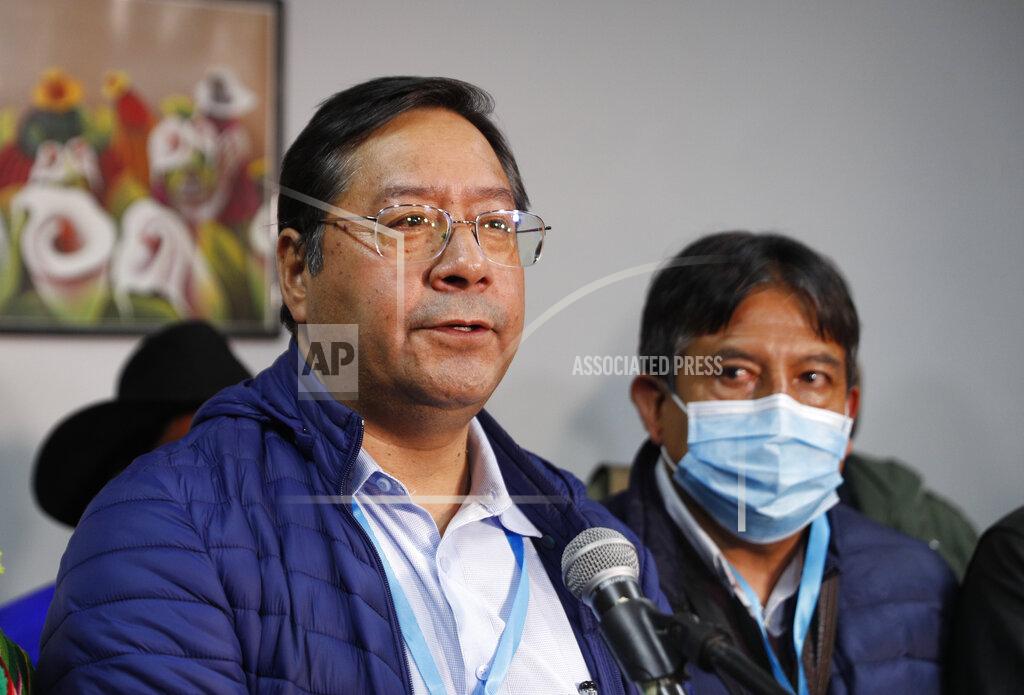 Juan Karita Luis Arce, presidential candidate for the Movement Towards Socialism (MAS) party, left, talks during a press conference after general elections in La Paz, Bolivia, Monday, Oct. 19, 2020. (AP Photo/Juan Karita)