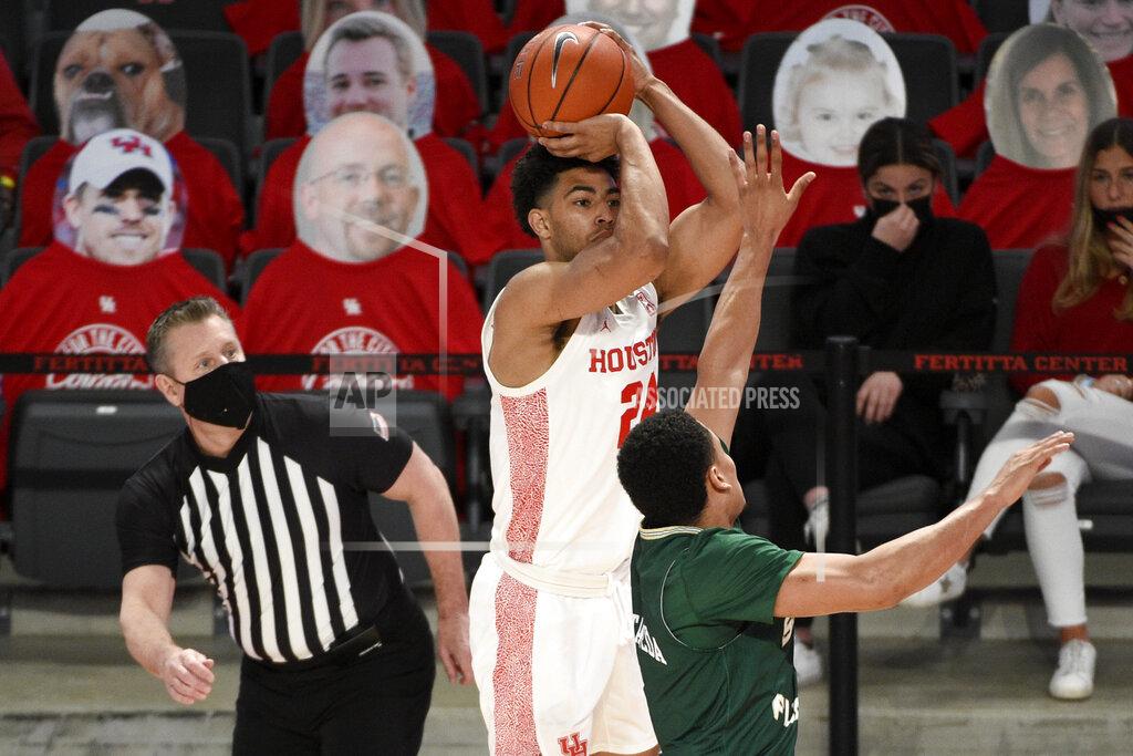 Eric Christian Smith Houston guard Quentin Grimes, center, shoots a three-point basket as South Florida guard Xavier Castaneda defends during the first half of an NCAA college basketball game, Sunday, Feb. 28, 2021, in Houston. (AP Photo/Eric Christian Smith)
