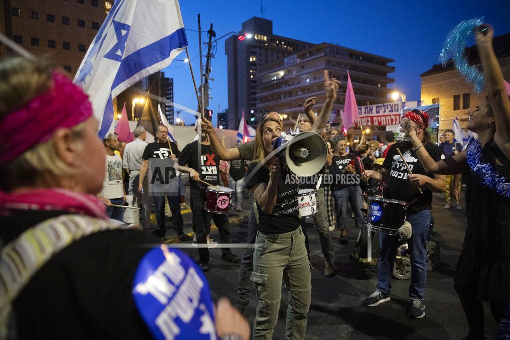 Ariel Schalit Israeli protesters dance and cheer during a demonstration against Israeli Prime Minister Benjamin Netanyahu outside his official residence in Jerusalem, Saturday, June 12, 2021. If all goes according to plan, Israel will swear in a new government on Sunday, ending Prime Minister Benjamin Netanyahu's record 12-year rule and a political crisis that inflicted four elections on the country in less than two years. (AP Photo/Ariel Schalit)